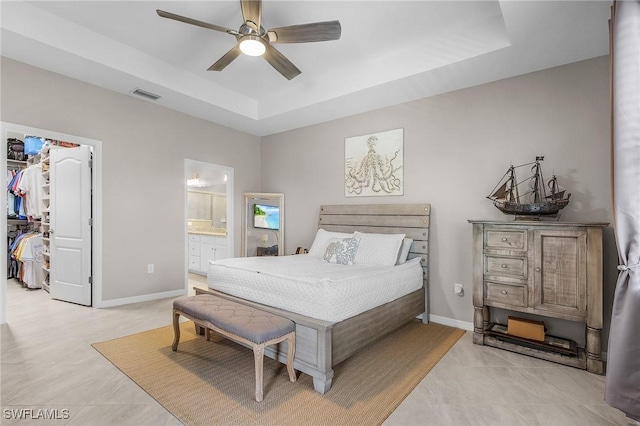 14659 Adina Ln, Fort Myers, FL 33905 - bedroom with a raised ceiling, a walk in closet, a closet, ensuite bathroom, and a ceiling fan