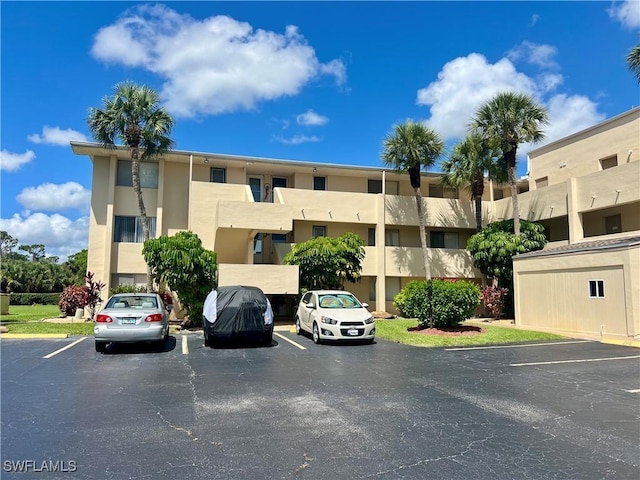 331 Joel Blvd Unit 109, Lehigh Acres, FL 33936 - view of property featuring uncovered parking