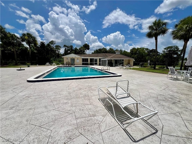 331 Joel Blvd Unit 109, Lehigh Acres, FL 33936 - community pool with a patio and view of scattered trees