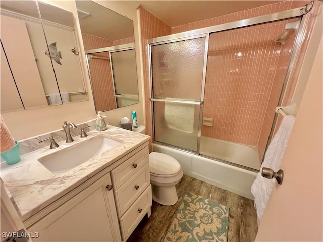 331 Joel Blvd Unit 109, Lehigh Acres, FL 33936 - bathroom featuring wood finished floors, vanity, and enclosed tub / shower combo