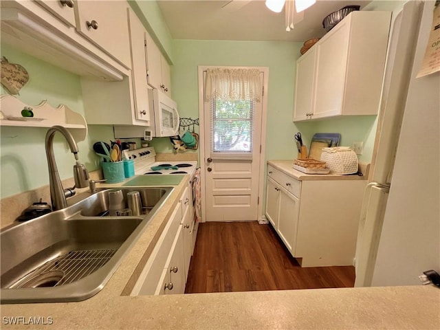 331 Joel Blvd Unit 109, Lehigh Acres, FL 33936 - kitchen with white appliances, dark wood finished floors, white cabinets, light countertops, and ceiling fan