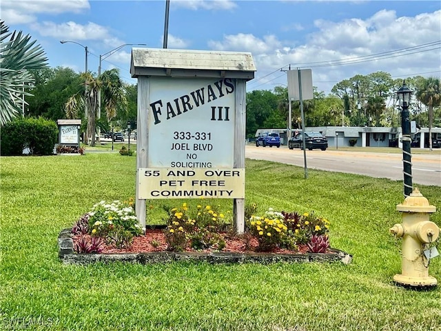 331 Joel Blvd Unit 109, Lehigh Acres, FL 33936 - community / neighborhood sign featuring a lawn