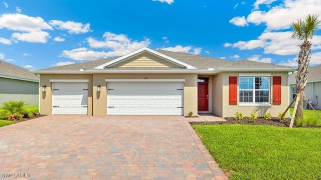 1010 NW 17th St, Cape Coral, FL 33993 - ranch-style house featuring decorative driveway, stucco siding, an attached garage, and a front lawn