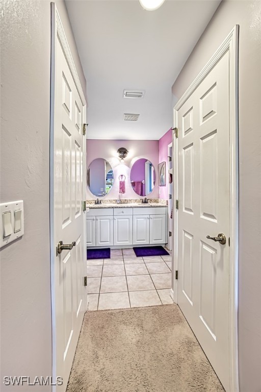 914 SW 9th Ct, Cape Coral, FL 33991 - full bathroom with double vanity and tile patterned floors