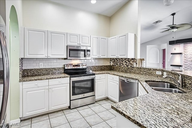 914 SW 9th Ct, Cape Coral, FL 33991 - kitchen with appliances with stainless steel finishes, decorative backsplash, a ceiling fan, lofted ceiling, and dark stone countertops