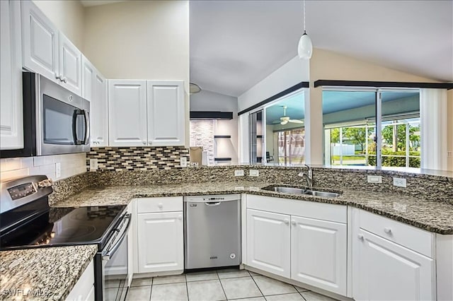 914 SW 9th Ct, Cape Coral, FL 33991 - kitchen with stainless steel appliances, lofted ceiling, backsplash, white cabinets, and light tile patterned floors