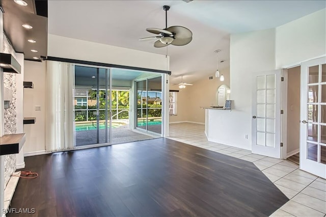 914 SW 9th Ct, Cape Coral, FL 33991 - unfurnished living room with ceiling fan, tile patterned flooring, lofted ceiling, and french doors