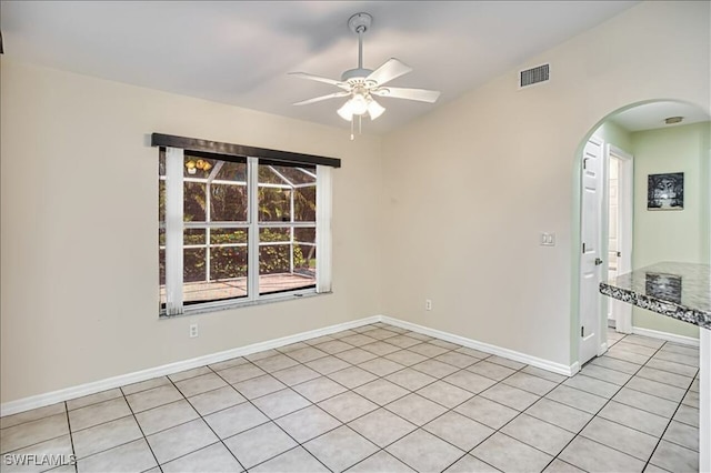 914 SW 9th Ct, Cape Coral, FL 33991 - empty room featuring arched walkways, a ceiling fan, and light tile patterned flooring