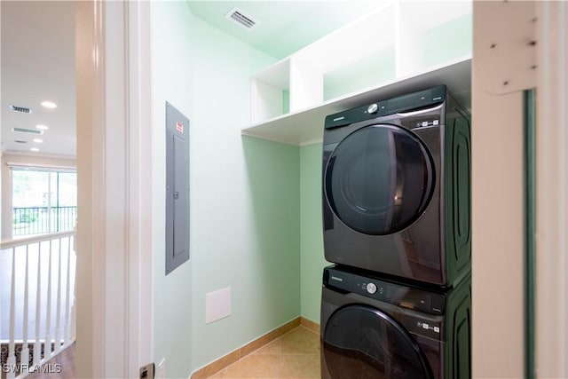 6533 Monterey Pt Unit 204, Naples, FL 34105 - laundry area with stacked washer / drying machine, light tile patterned flooring, and electric panel