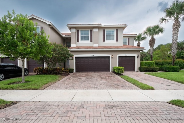 6533 Monterey Pt Unit 204, Naples, FL 34105 - multi unit property featuring an attached garage, decorative driveway, stucco siding, and a tiled roof