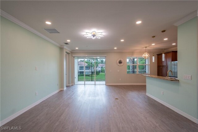 6533 Monterey Pt Unit 204, Naples, FL 34105 - unfurnished living room with crown molding, recessed lighting, wood finished floors, and a chandelier