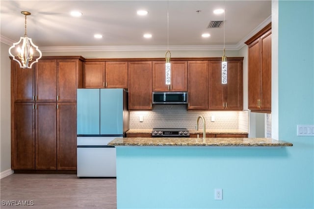 6533 Monterey Pt Unit 204, Naples, FL 34105 - kitchen featuring stainless steel microwave, freestanding refrigerator, stone countertops, hanging light fixtures, and crown molding