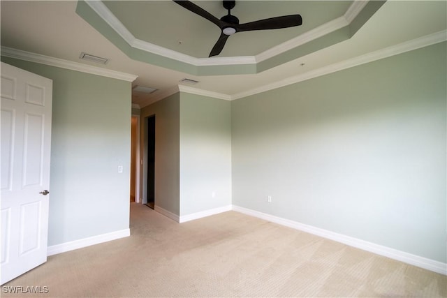 6533 Monterey Pt Unit 204, Naples, FL 34105 - spare room featuring a tray ceiling, light carpet, a ceiling fan, and ornamental molding