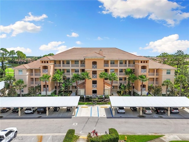 10720 Palazzo Way Unit 405, Fort Myers, FL 33913 - view of apartment building / complex with covered and uncovered parking