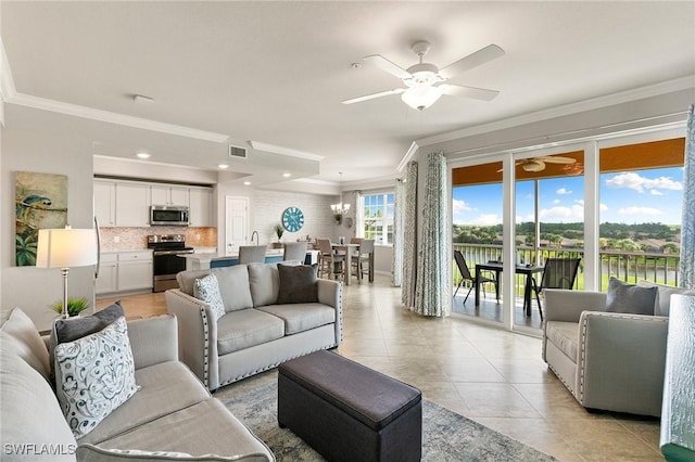 10720 Palazzo Way Unit 405, Fort Myers, FL 33913 - living room featuring ornamental molding, a ceiling fan, light tile patterned floors, and a chandelier