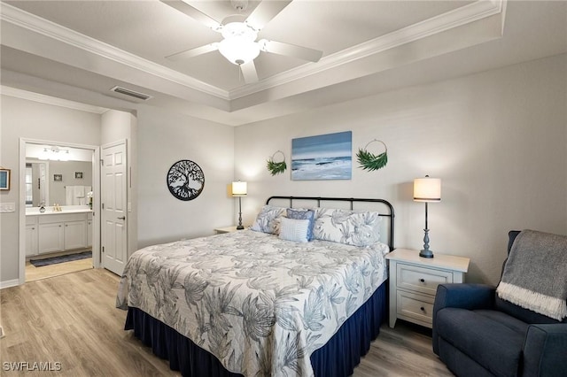10720 Palazzo Way Unit 405, Fort Myers, FL 33913 - bedroom featuring a tray ceiling, light wood finished floors, ornamental molding, ensuite bathroom, and a ceiling fan