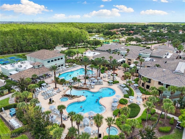 10720 Palazzo Way Unit 405, Fort Myers, FL 33913 - bird's eye view of a pool and a heavily wooded area