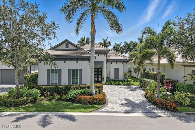 3159 Heather Glen Ct, Naples, FL 34114 - view of front of house featuring french doors, stucco siding, driveway, and a tile roof