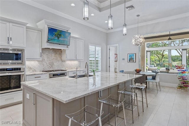 3159 Heather Glen Ct, Naples, FL 34114 - kitchen featuring appliances with stainless steel finishes, exhaust hood, backsplash, a spacious island, and white cabinetry