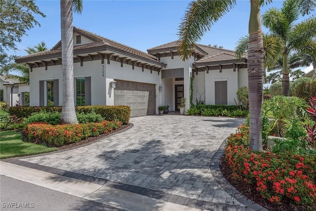 3159 Heather Glen Ct, Naples, FL 34114 - view of front of property with a garage, stucco siding, decorative driveway, and a tiled roof