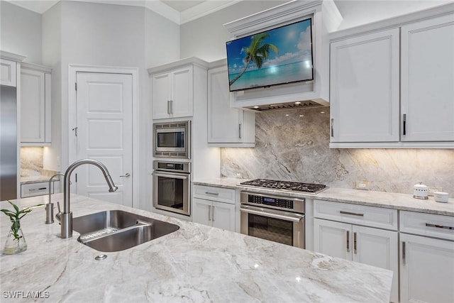 3159 Heather Glen Ct, Naples, FL 34114 - kitchen featuring appliances with stainless steel finishes, white cabinets, backsplash, crown molding, and light stone countertops