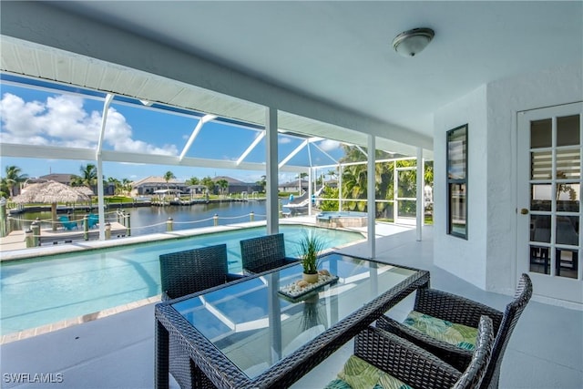 2812 SW 46th Ter, Cape Coral, FL 33914 - view of patio / terrace featuring a water view, glass enclosure, and a pool with connected hot tub