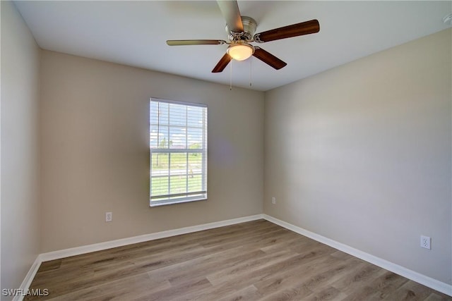 109 NE 11th St, Cape Coral, FL 33909 - empty room featuring wood finished floors, a ceiling fan, and a smoke detector
