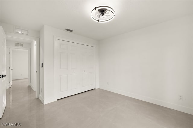 614 Ames St E, Lehigh Acres, FL 33974 - unfurnished bedroom featuring baseboards and a closet