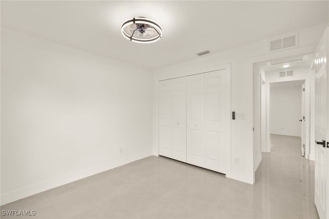614 Ames St E, Lehigh Acres, FL 33974 - unfurnished bedroom featuring a closet and tile patterned flooring