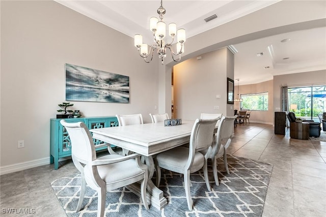 1387 Mockingbird Dr, Naples, FL 34120 - dining room with crown molding, a chandelier, tile patterned floors, and arched walkways