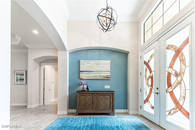 1387 Mockingbird Dr, Naples, FL 34120 - entrance foyer with arched walkways, french doors, a chandelier, crown molding, and recessed lighting