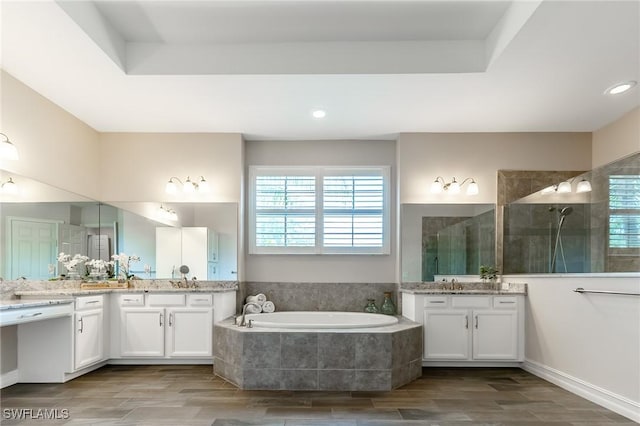 1387 Mockingbird Dr, Naples, FL 34120 - full bath featuring a garden tub, a walk in shower, two vanities, and wood finished floors