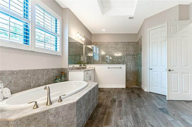 1387 Mockingbird Dr, Naples, FL 34120 - full bath featuring vanity, a bath, a tile shower, and wood finished floors