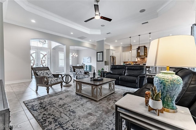 1387 Mockingbird Dr, Naples, FL 34120 - living room featuring arched walkways, a tray ceiling, ornamental molding, a ceiling fan, and recessed lighting
