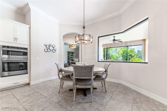 1387 Mockingbird Dr, Naples, FL 34120 - dining space with crown molding, a chandelier, arched walkways, and light tile patterned floors
