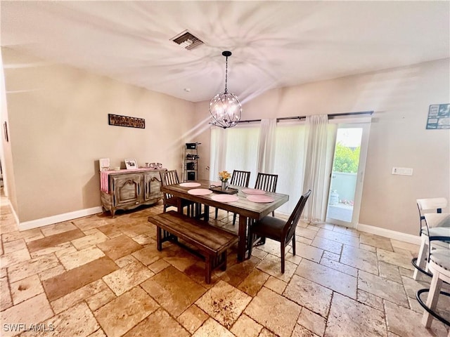 3307 33rd St W, Lehigh Acres, FL 33971 - dining room with stone tile flooring, a chandelier, and vaulted ceiling