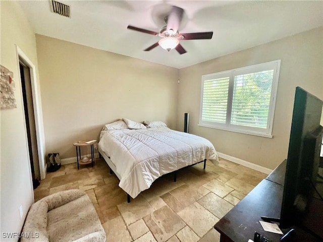 3307 33rd St W, Lehigh Acres, FL 33971 - bedroom with stone tile flooring and ceiling fan