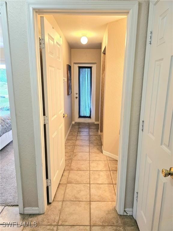 619 Charles Sise St, Lehigh Acres, FL 33974 - corridor featuring baseboards and light tile patterned floors