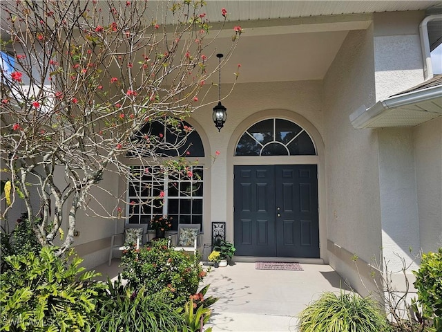 619 Charles Sise St, Lehigh Acres, FL 33974 - property entrance featuring stucco siding