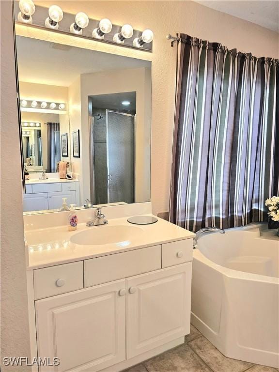 619 Charles Sise St, Lehigh Acres, FL 33974 - bathroom with a bath, vanity, tile patterned floors, and a shower stall
