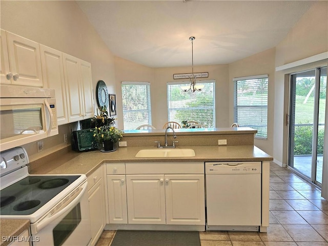 619 Charles Sise St, Lehigh Acres, FL 33974 - kitchen with white appliances, a peninsula, vaulted ceiling, white cabinetry, and a chandelier