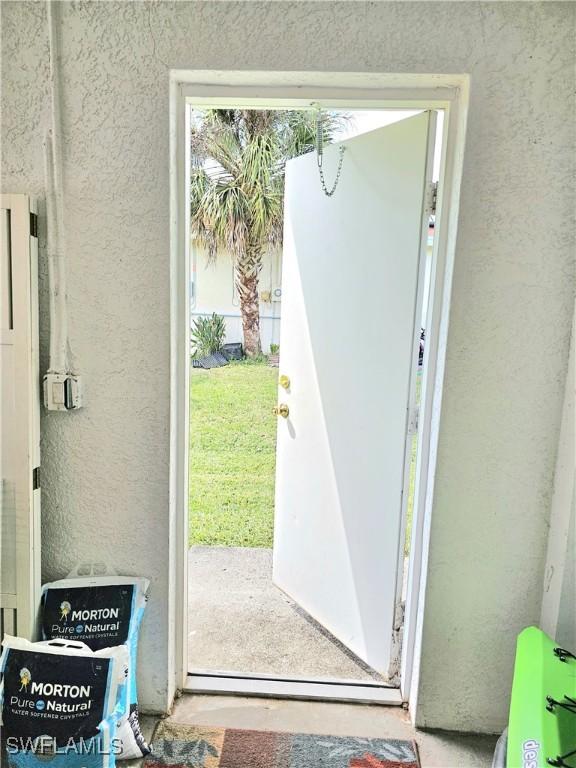 619 Charles Sise St, Lehigh Acres, FL 33974 - entryway featuring a textured wall