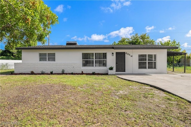 207 Leeland Heights Blvd W, Lehigh Acres, FL 33936 - ranch-style house with stucco siding, concrete driveway, and brick siding