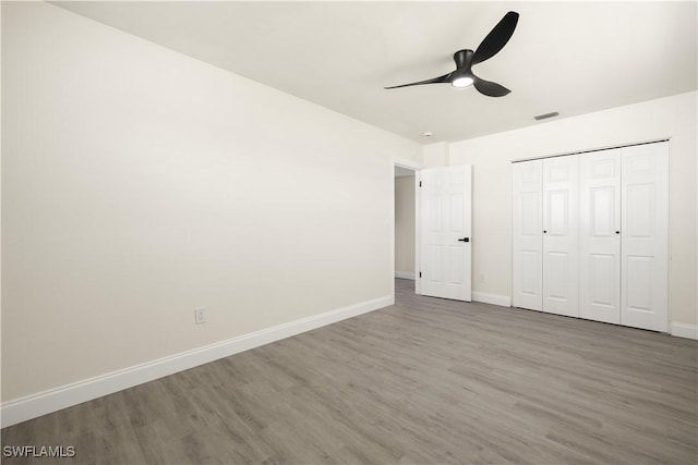 207 Leeland Heights Blvd W, Lehigh Acres, FL 33936 - unfurnished bedroom featuring wood finished floors, a ceiling fan, and a closet
