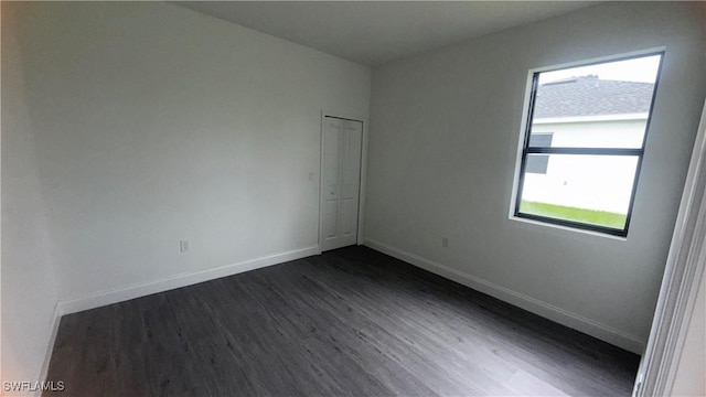 933 Gleason St, Lehigh Acres, FL 33974 - spare room featuring plenty of natural light and dark wood finished floors