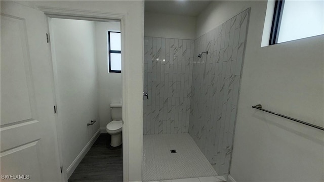 933 Gleason St, Lehigh Acres, FL 33974 - full bathroom with a shower stall, plenty of natural light, and wood finished floors