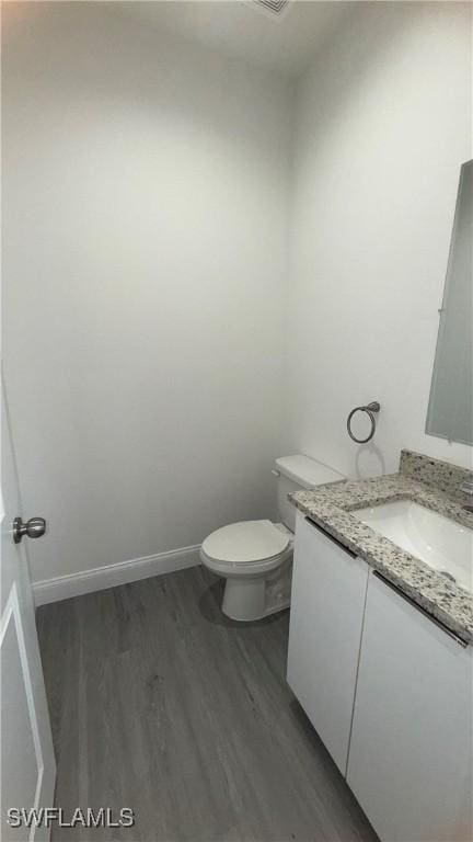 933 Gleason St, Lehigh Acres, FL 33974 - half bathroom featuring vanity and wood finished floors