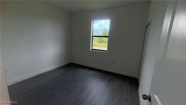 933 Gleason St, Lehigh Acres, FL 33974 - spare room featuring dark wood finished floors and baseboards