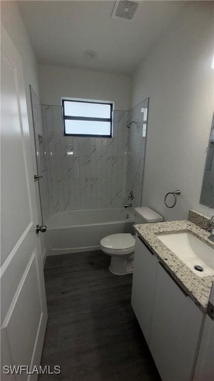 933 Gleason St, Lehigh Acres, FL 33974 - full bathroom featuring vanity, shower / tub combination, and wood finished floors