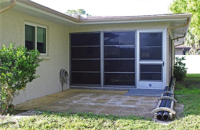 2119 Pellam Blvd, Port Charlotte, FL 33948 - view of property exterior with stucco siding and a patio